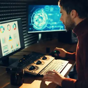 Male Videographer Edits and Cuts Footage and Sound on His Personal Computer